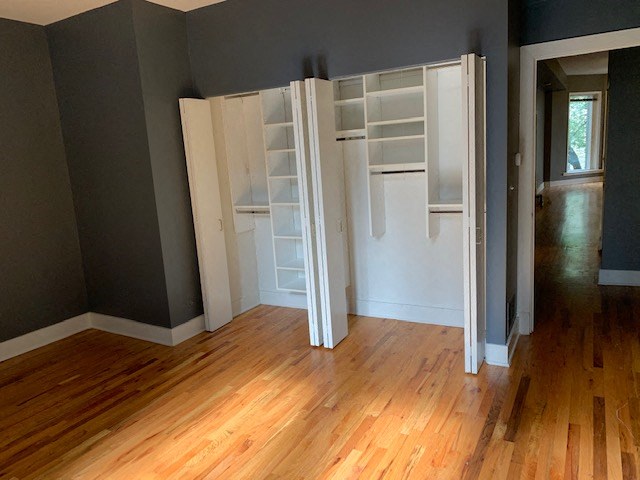 an empty room with an open closet in it