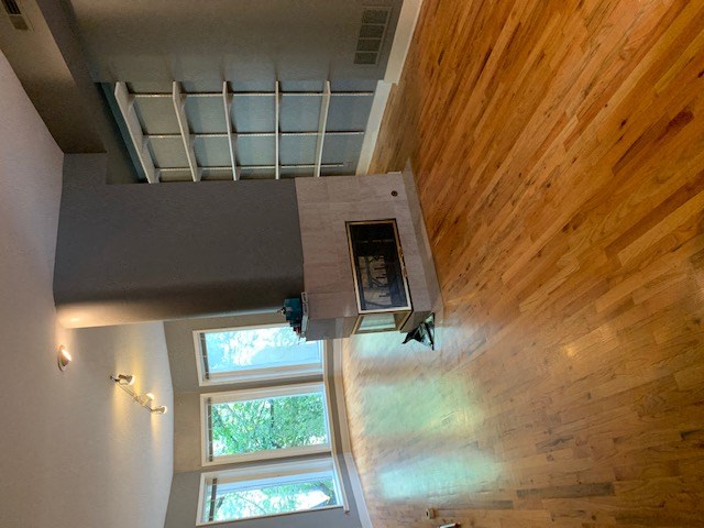 an overhead view of a living room with wood floors and a window