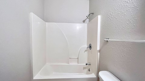 a small bathroom with a shower and a sink