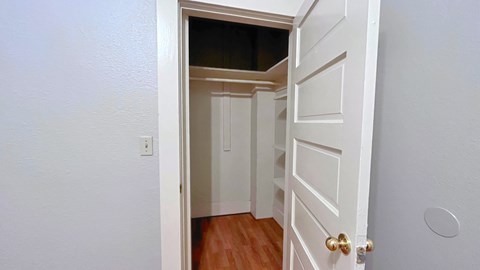 a bedroom with a door open to a closet