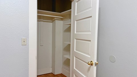 the closet in a small room with an open door
