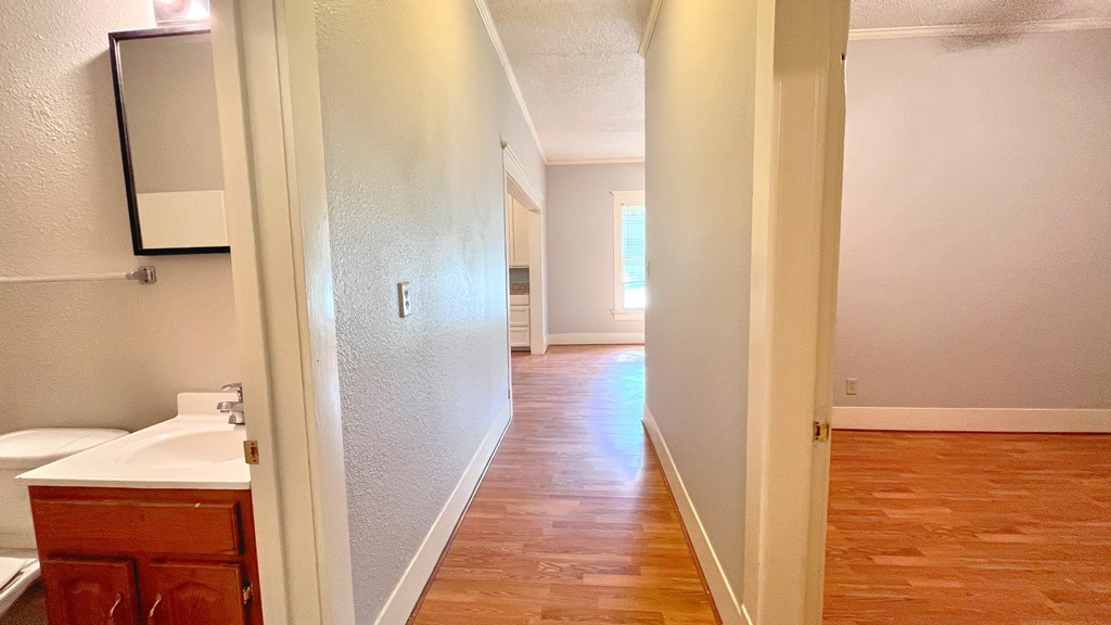 the view from the bathroom into the living room and dining room