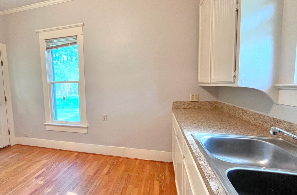 a kitchen with granite counter tops and a window