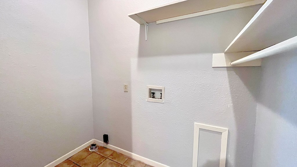 an empty room with a white wall and a window and a white shelf and a