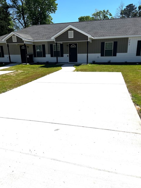 a white driveway in front of a house