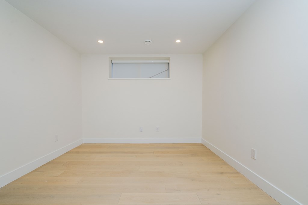 an empty room with white walls and a window