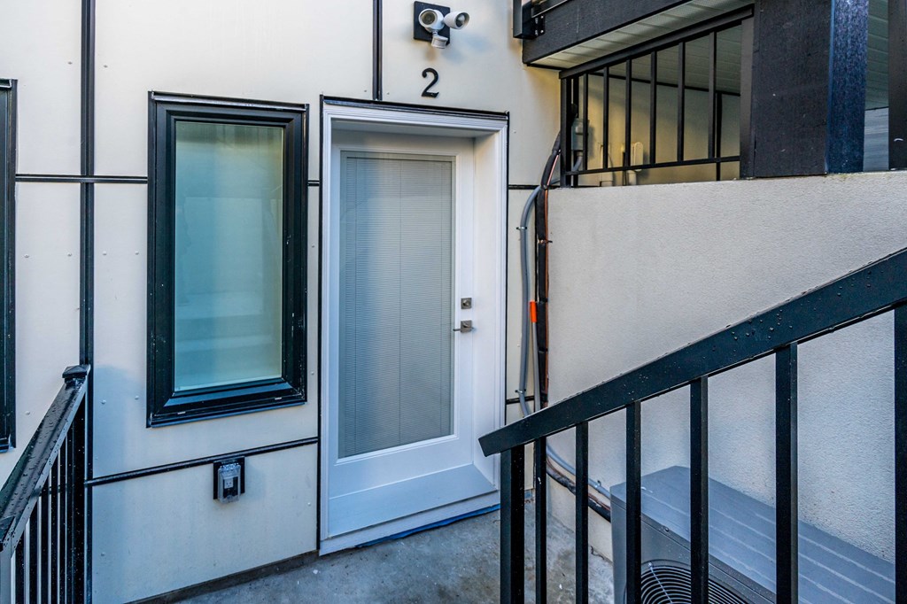 a door on the side of a building next to a staircase