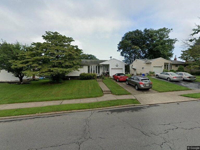 a neighborhood with cars parked in front of houses