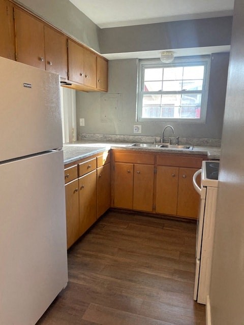 an empty kitchen with a refrigerator and a sink