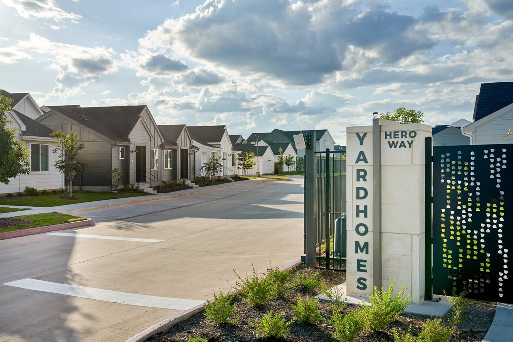 Yardhomes sign in front of a row of houses.