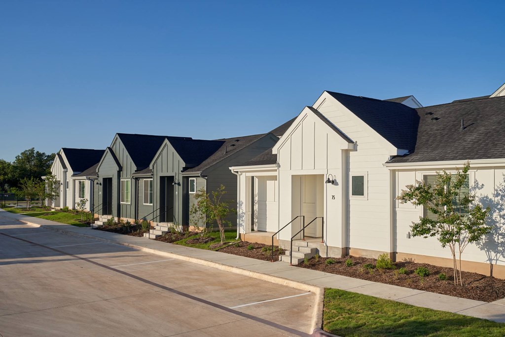 A row of houses with grey and white exteriors.