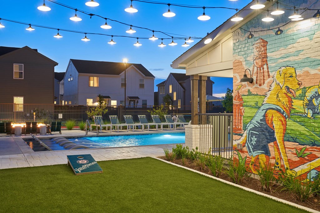 A pool area with a mural of a dog and a person.