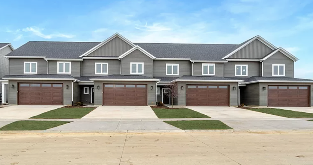 a large house with three garage doors