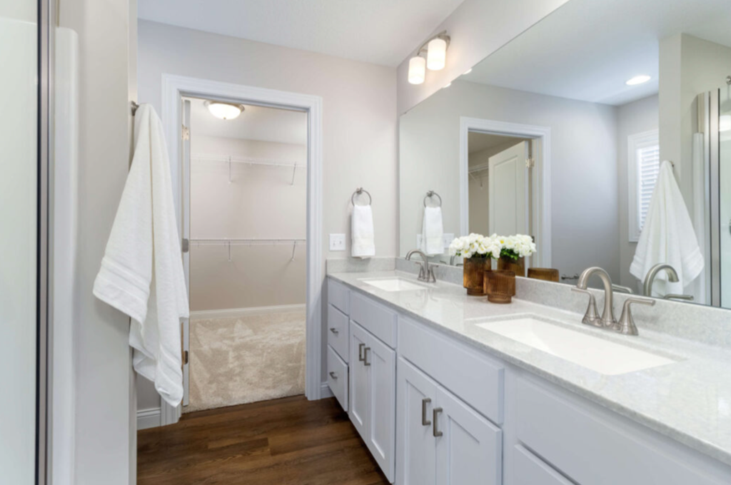 a bathroom with a sink and a shower and a mirror