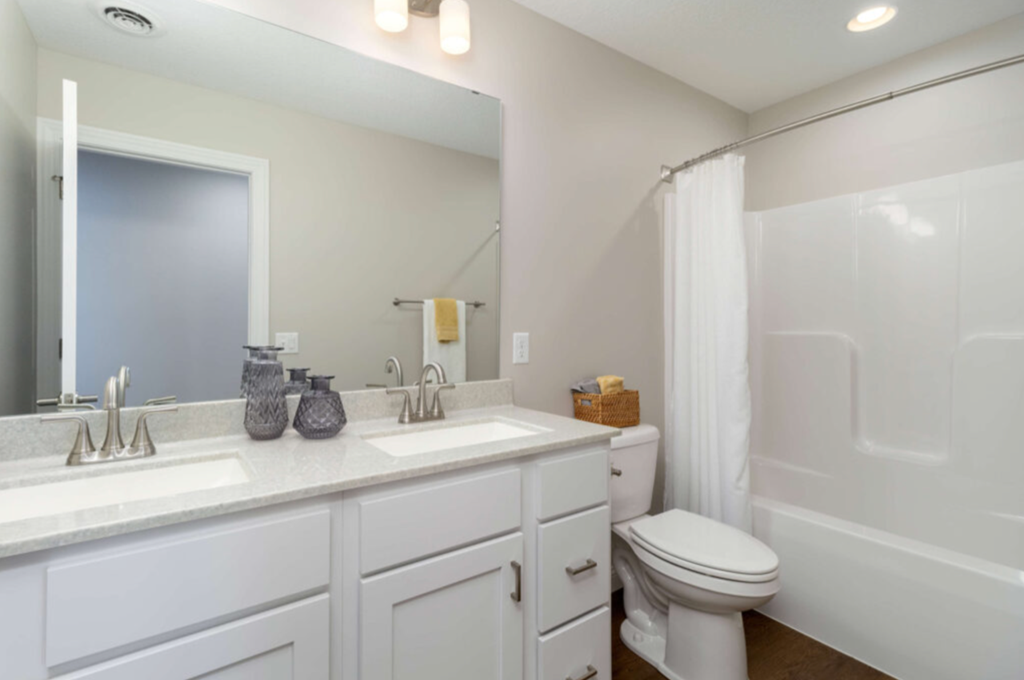 a white bathroom with a toilet and a sink