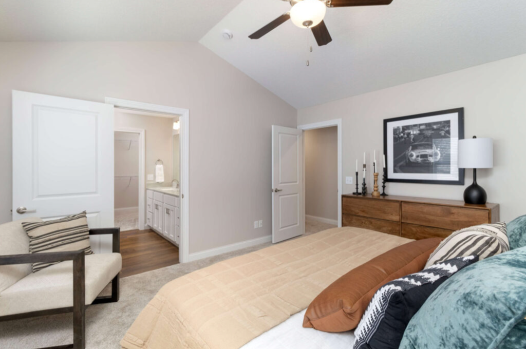 a bedroom with a large bed and a ceiling fan