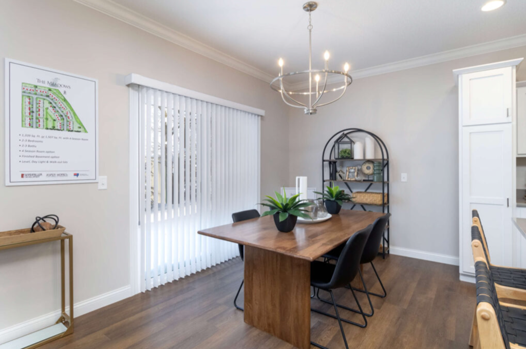 a dining room with a wooden table and chairs and a chandelier