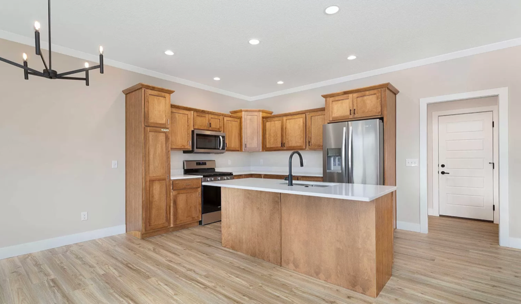 an empty kitchen with wooden cabinets and a counter top