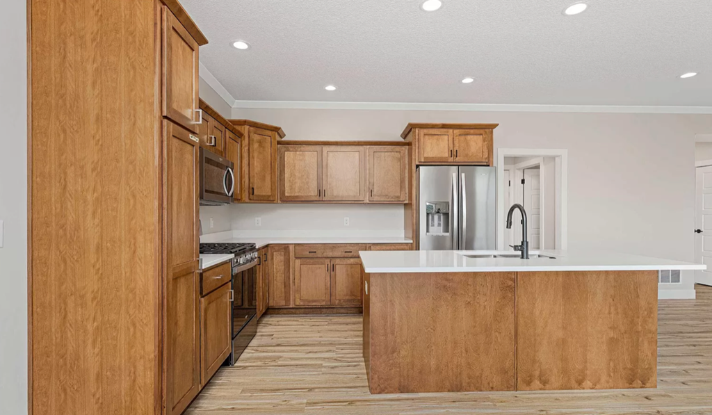 a kitchen with wooden cabinets and a white counter top