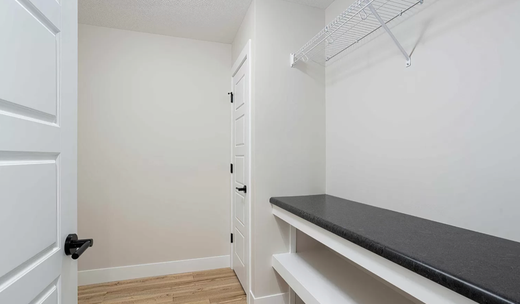 a room with a bench and a closet