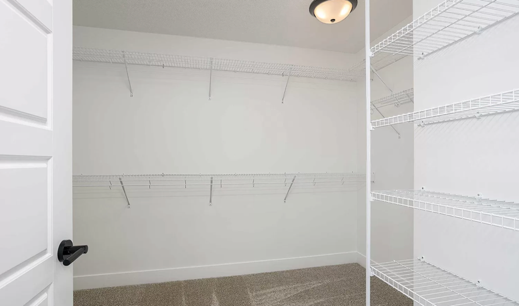 the closet in a bedroom of a home with shelves