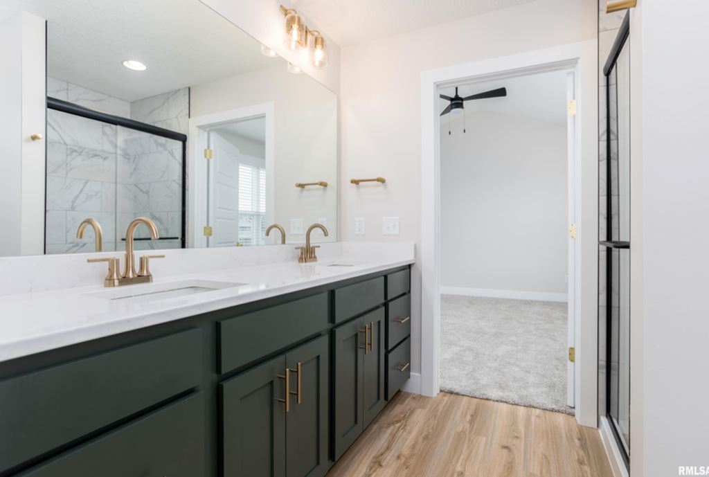a bathroom with a sink and a mirror and a shower