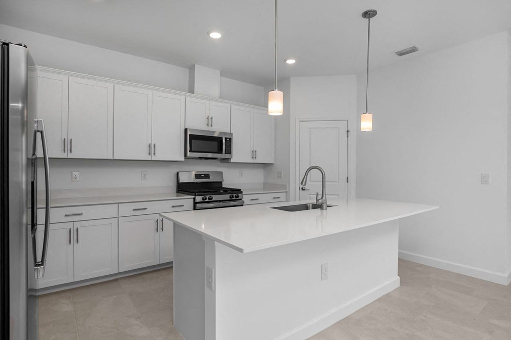 a kitchen with white cabinets and a white counter top