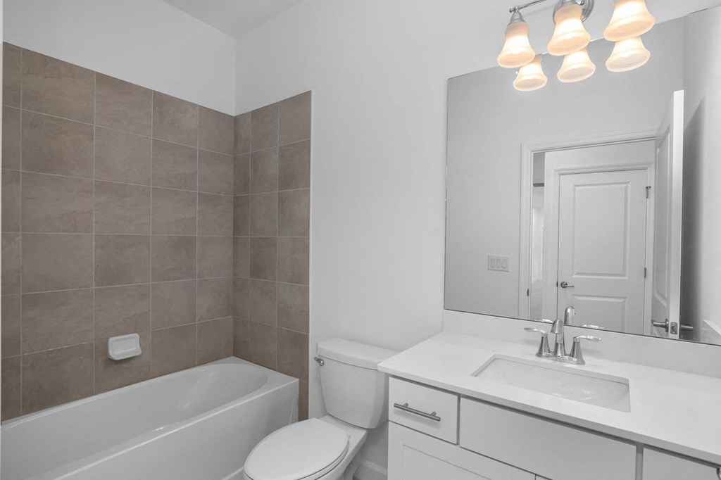 a bathroom with a sink toilet and a bath tub