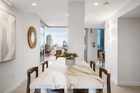 A dining room with a long table and chairs.