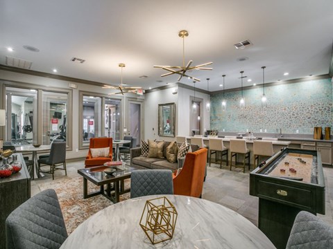 A modern dining room with a pool table and a bar area.