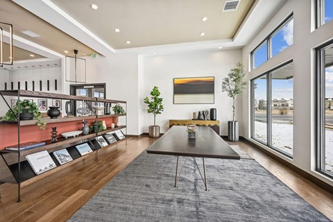 A modern dining room with a long table and chairs.