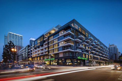 A modern building with a green sign on the front.
