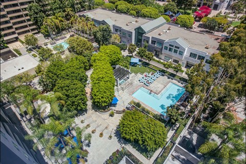 A bird's eye view of a residential area with a swimming pool.