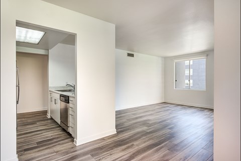 A kitchen with a dishwasher and a refrigerator.
