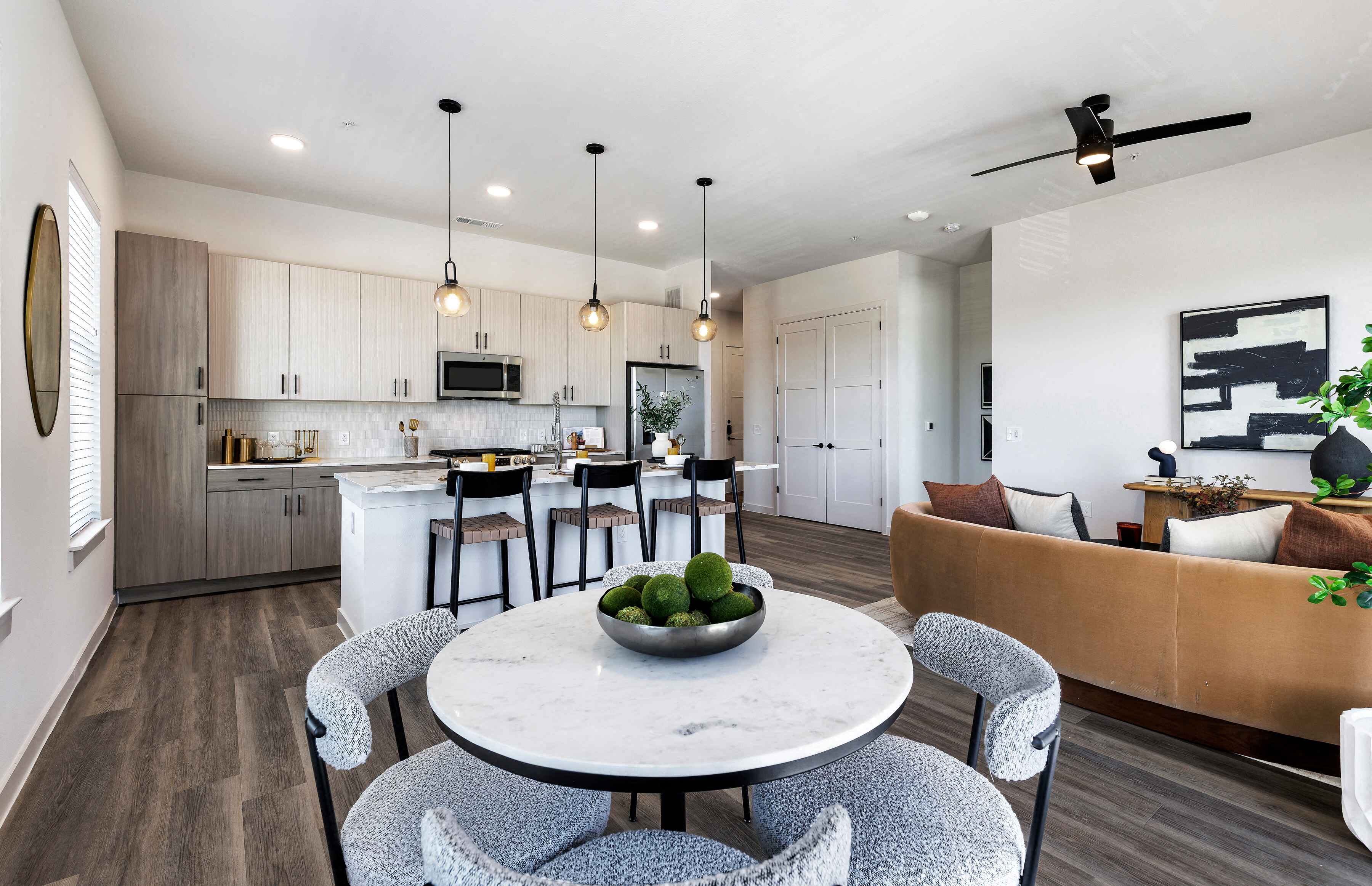 A modern kitchen with a dining table and chairs.