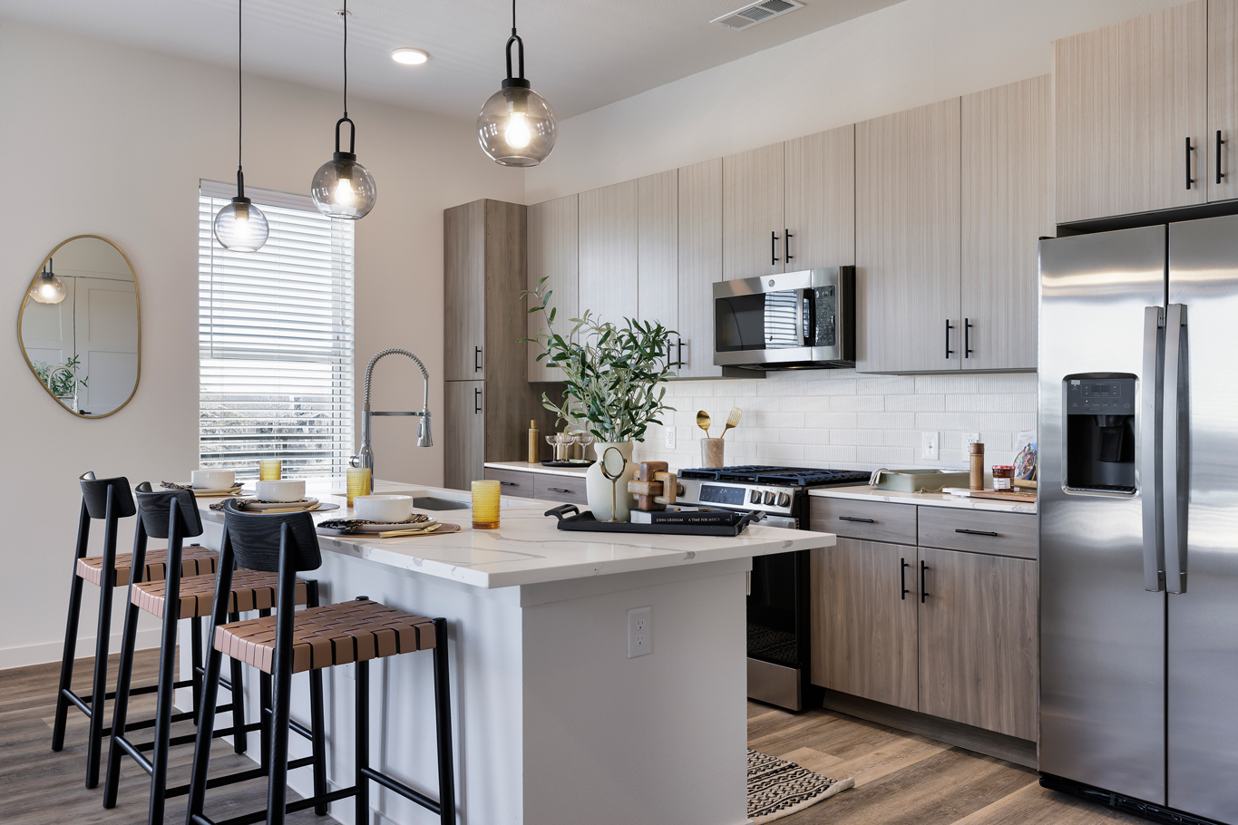 A kitchen with a white countertop and wooden cabinets.