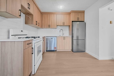 A kitchen with wooden cabinets and white appliances.