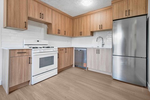 A kitchen with wooden cabinets and stainless steel appliances.