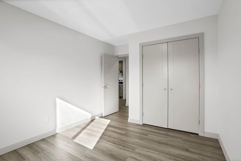 A room with a white door and a white cabinet.