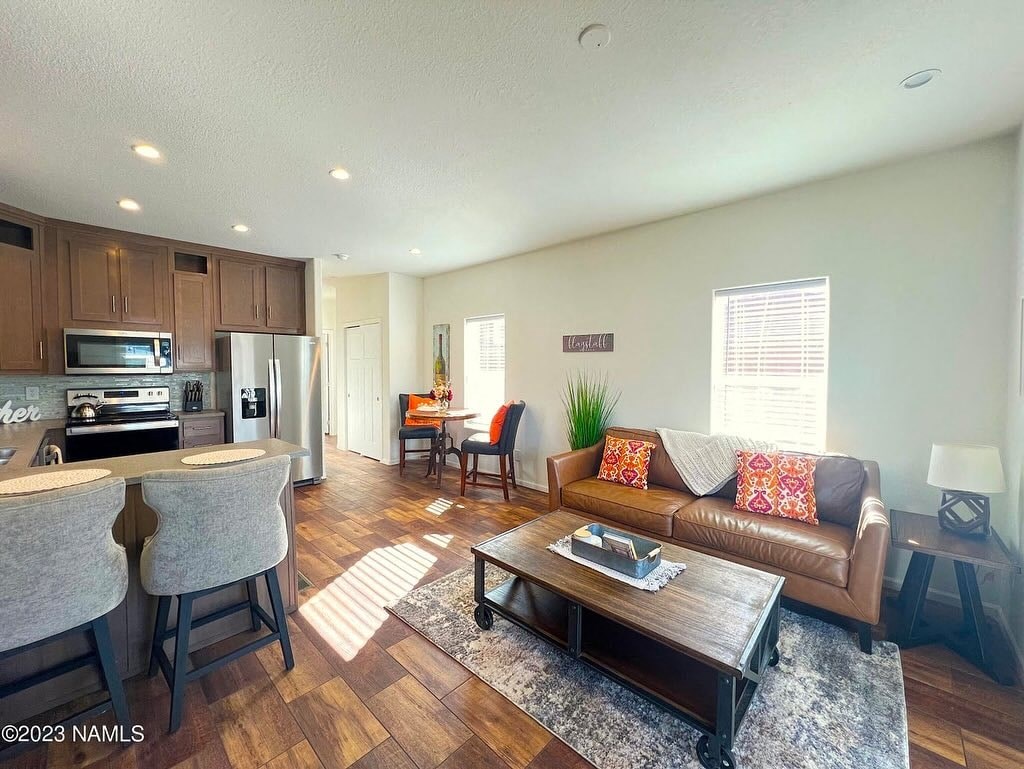 a living room and kitchen with a couch and a table