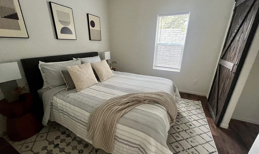 a bedroom with a bed and some pillows on it