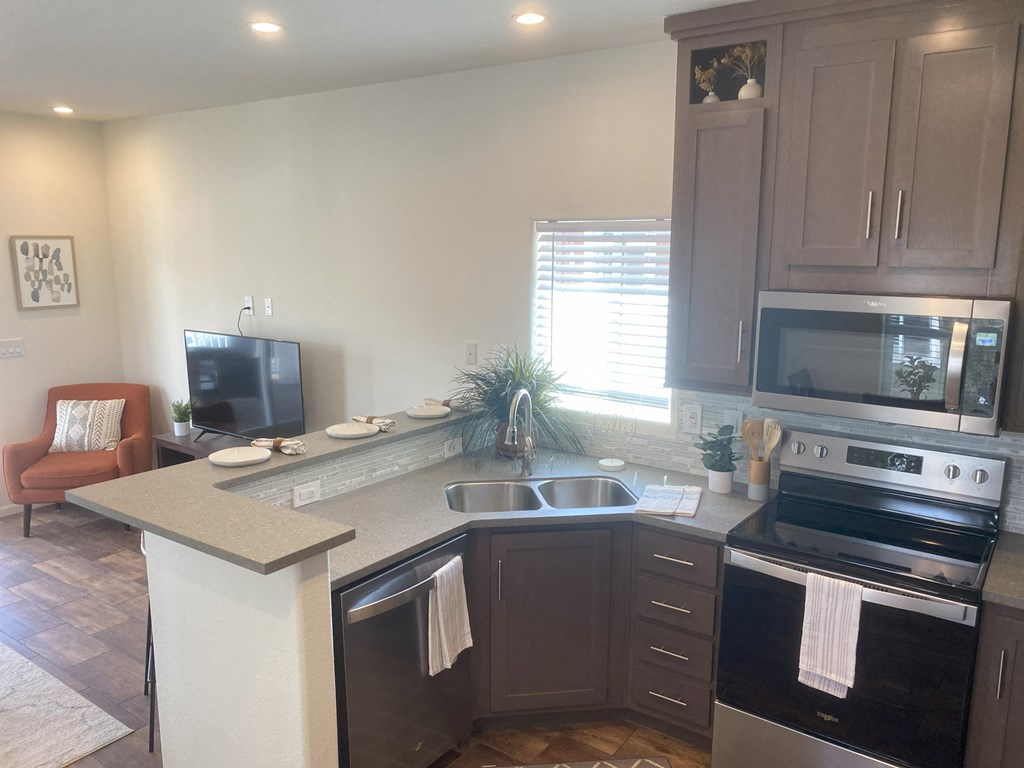a kitchen with a counter top and a stove and a sink