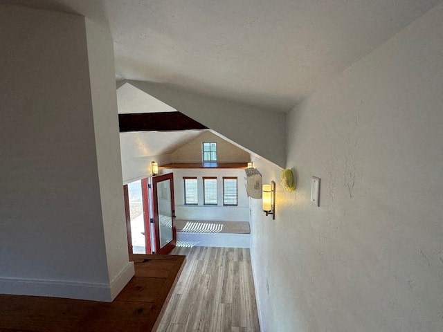a hallway with white walls and a door to a house