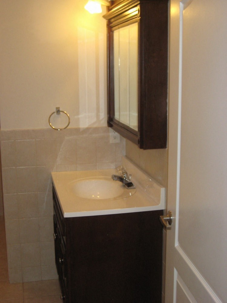 a small bathroom with a sink and a mirror