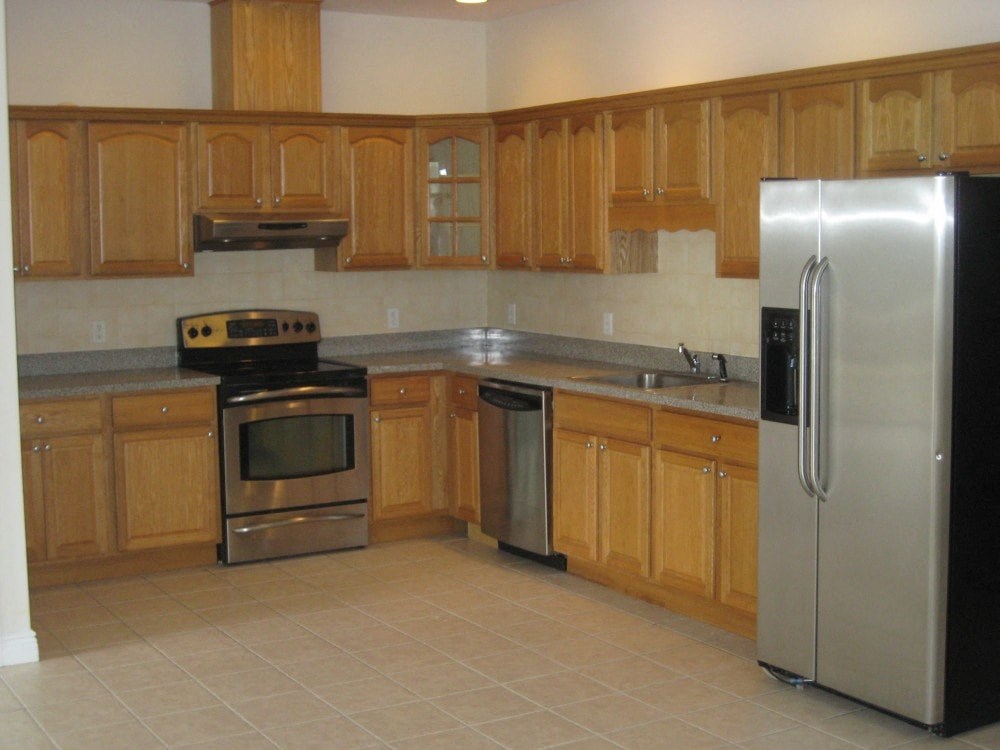 a kitchen with stainless steel appliances and wooden cabinets