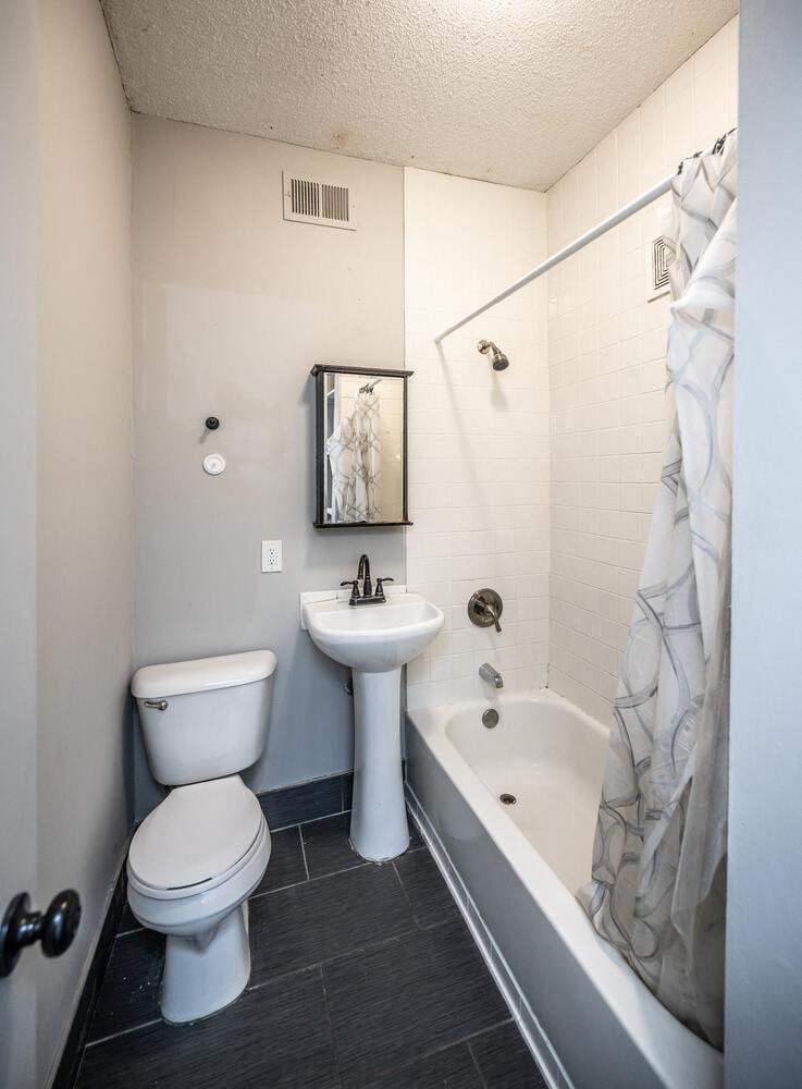 a bathroom with a sink toilet and a tub