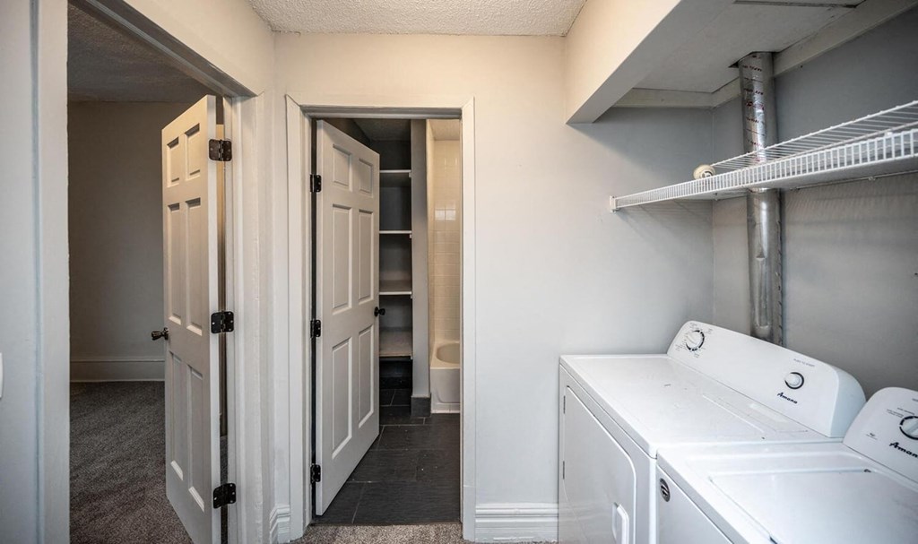 a laundry room with a washer and dryer and a closet