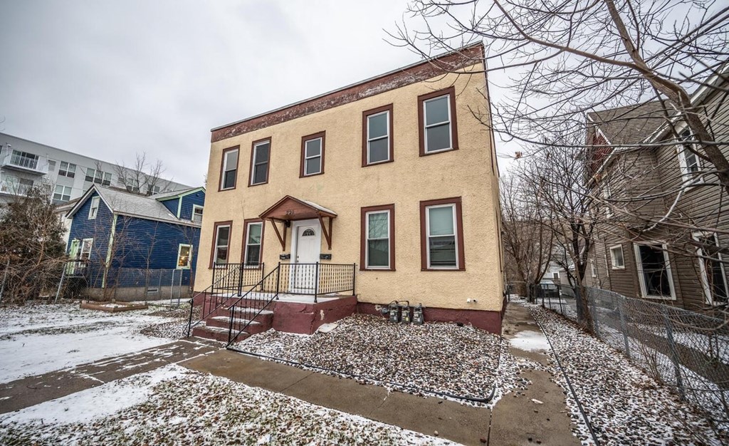 the front of a house with snow on the ground