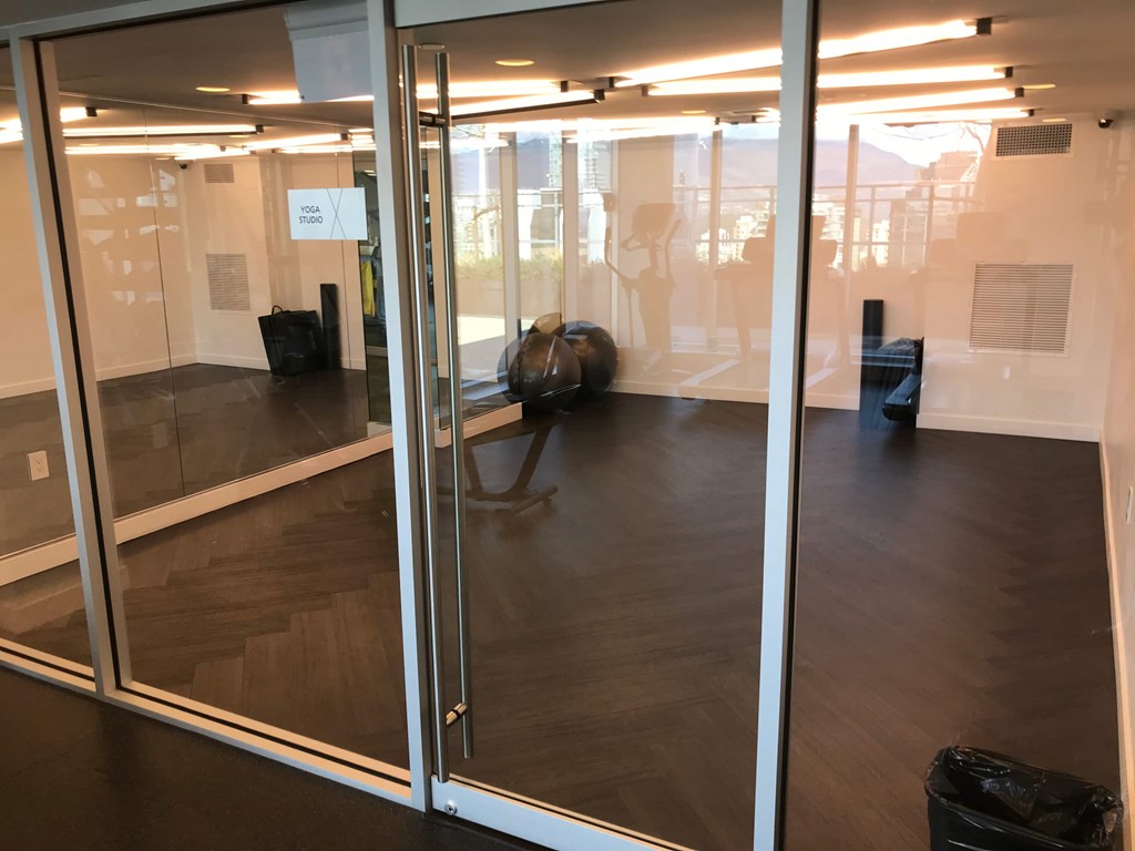 a conference room with glass doors and a table with luggage