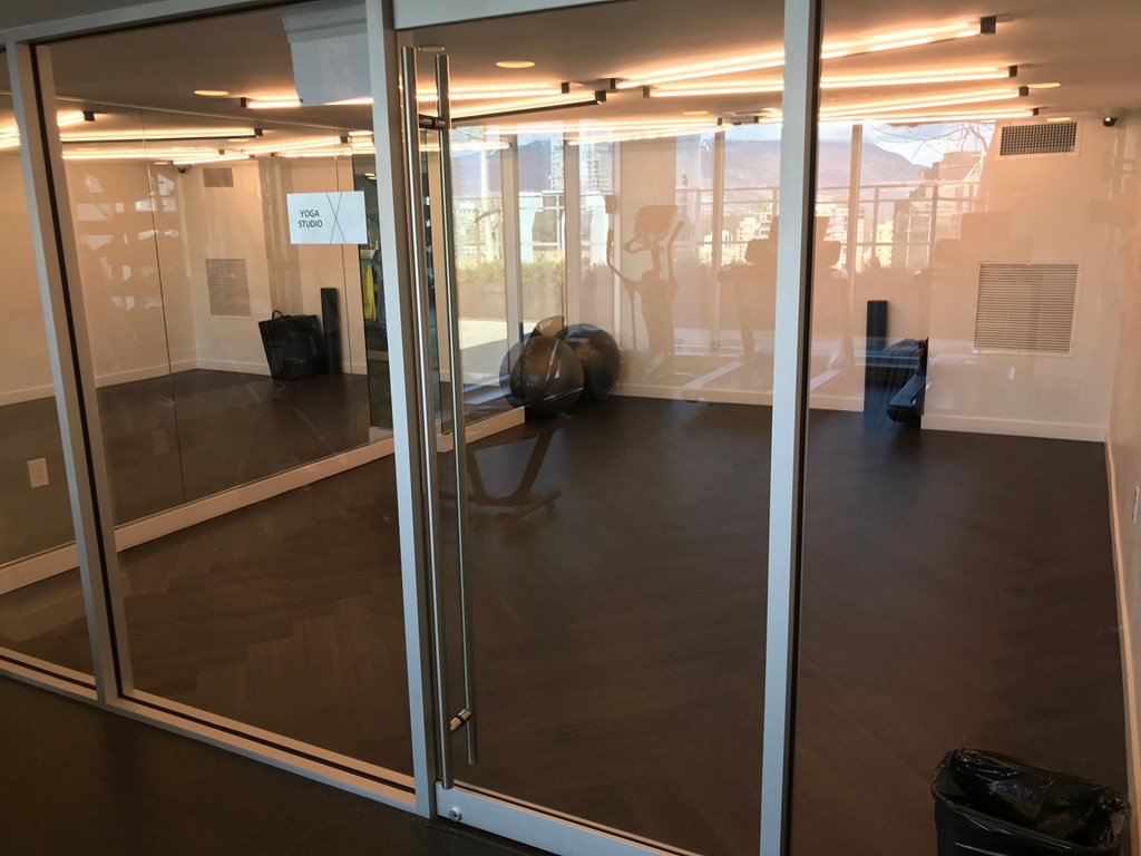 a large room with glass doors and a table in the middle